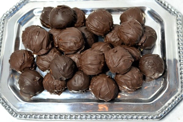 peanut butter balls on a silver serving tray