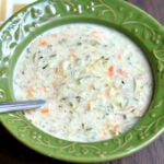 creamy zucchini soup in a green bowl