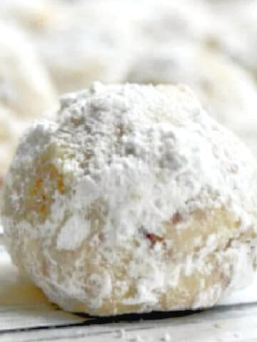 closeup of a snowball cookie covered in powdered sugar