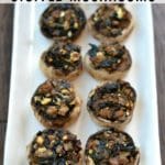 stuffed mushrooms lined on a white plate