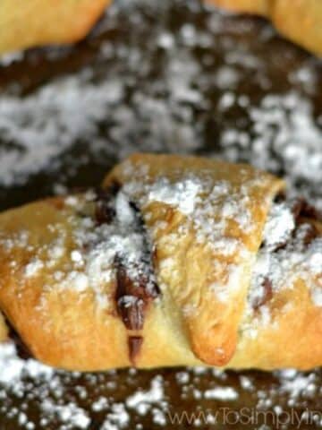 crescent roll baked with nutella on the inside and sprinkled with powdered sugar.