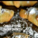 crescent roll filled with nutella spread and topped with powdered sugar with next overlay