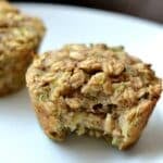 closeup of a zucchini oatmeal muffin with a bite taken out of it.