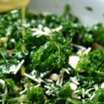 closeup of kale salad with parmesan cheese and sliced almonds.