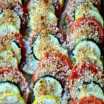 sliced zucchini, yelllow squash and tomatoes lined in a casserole dish and topped with breadcrumbs.