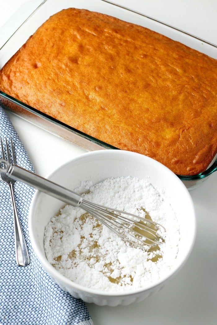 overhead picture cooked sheet cake with bowl of powdered sugar