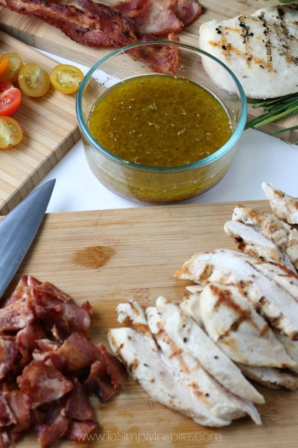 Chopped Bacon and Sliced Chicken on a wood cutting board with a knife