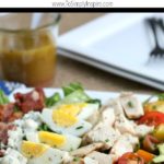 Cobb Salad Recipe layered with chicken , bacon, tomatoes, hardboiled eggs and avocado