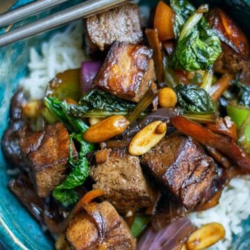 Kung Pao Tofu in a blue bowl with chopsticks