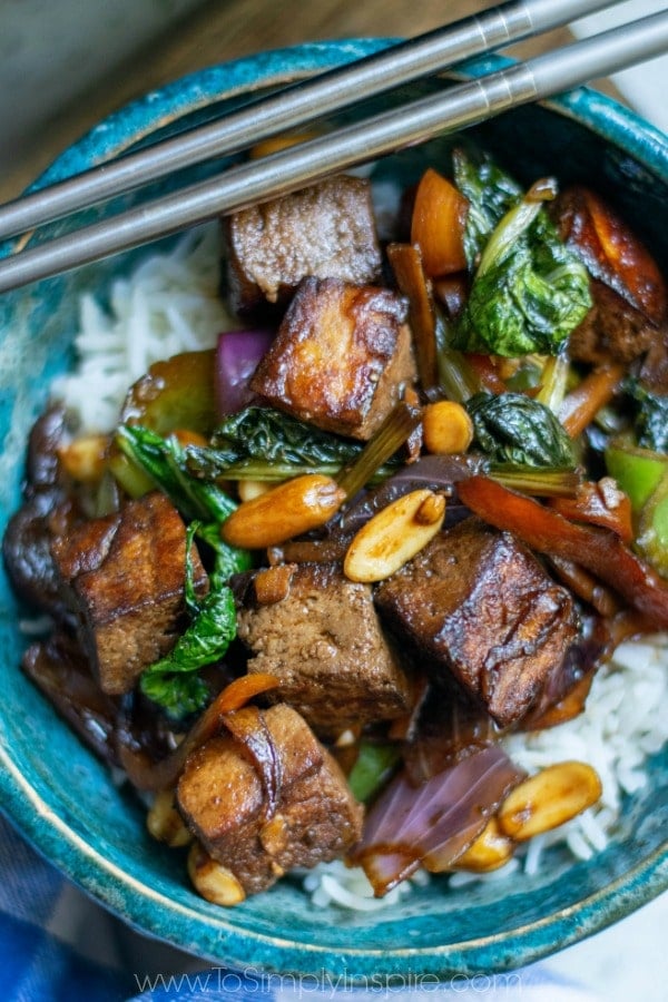 Kung Pao Tofu in a blue bowl with chopsticks