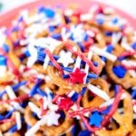 A close up of food, with red white and blue Pretzel and Sprinkles