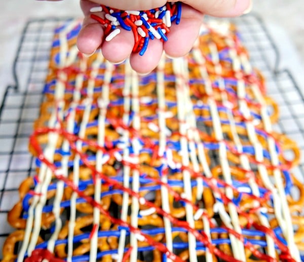 A close up of red white and blue pretzels with sprinkles