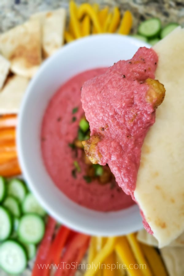 closeup of beet hummus on pita bread