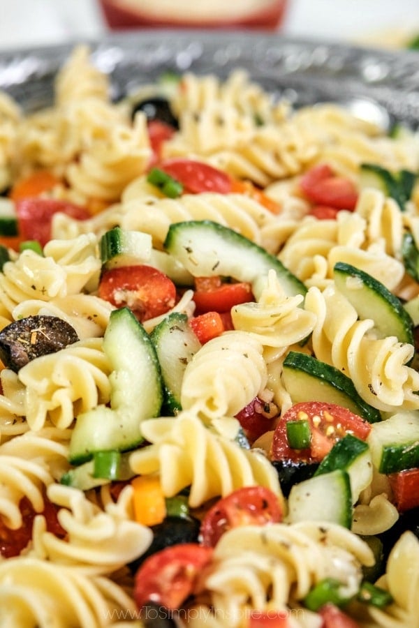 closeup of pasta salad with tomatoes, olives and cucumbers