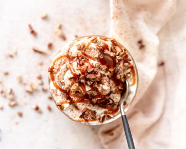 top of a pumpkin cheesecake trifle topped with pecan pieces and drizzled in caramel