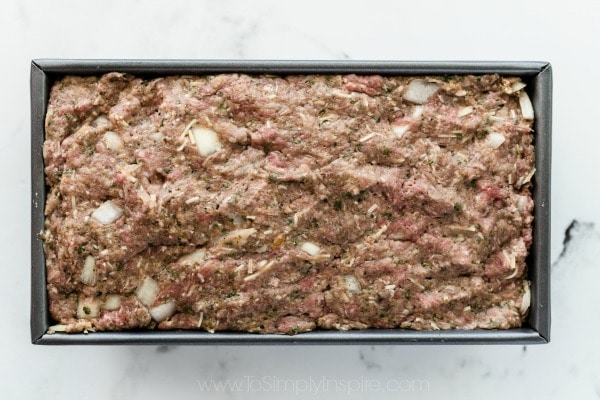 uncooked meatloaf in a metal loaf pan