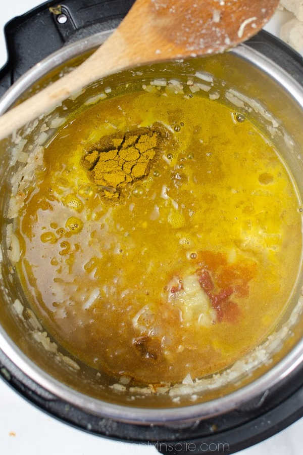 curry sauce in an Instant pot with a wooden spoon