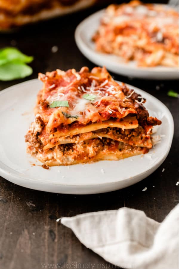 closeup slice of lasagna on a white plate