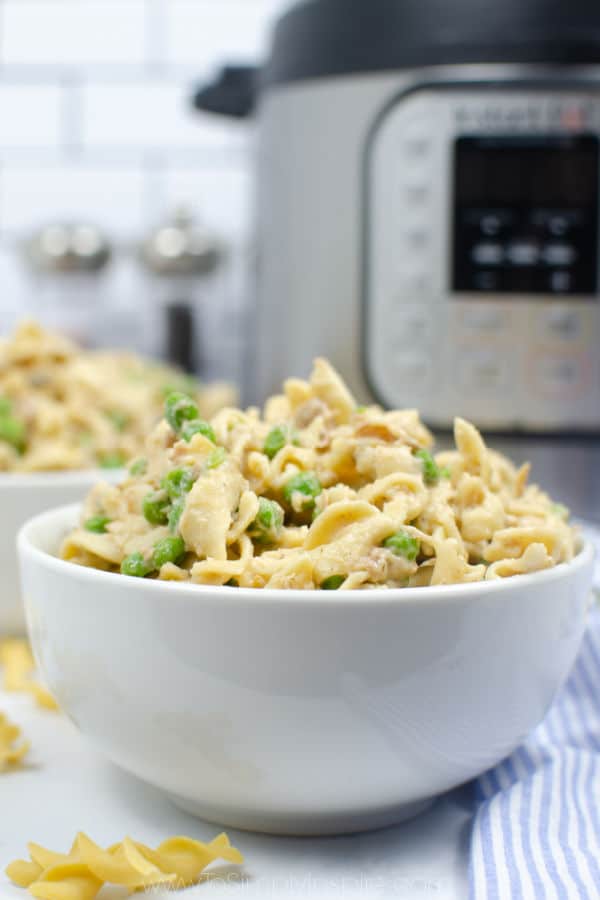 closeup of tuna casserole in a white bowl with instant pot in background