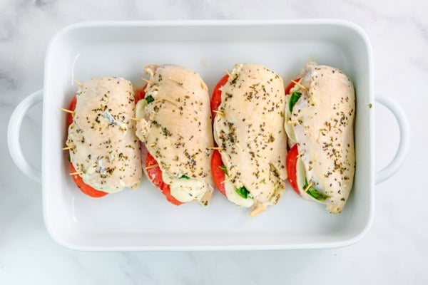 four chicken breast stuffed with tomatoes, mozzarella and basil