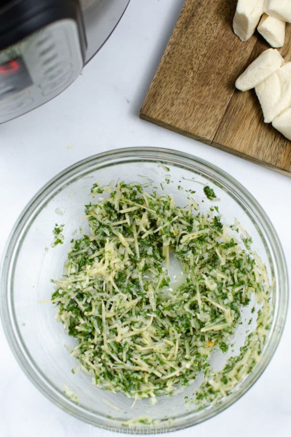 parsley and parmesan cheese mixture in a glass bowl