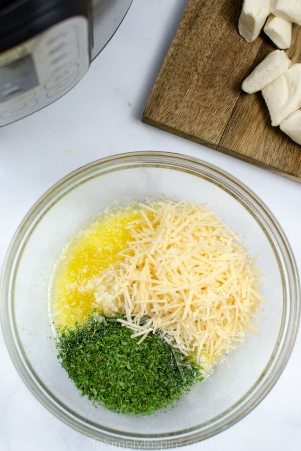 parsley parmesan cheese and melted butter in a glass bowl