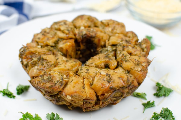 garlic parmesan monkey pull apart bread on a white plate