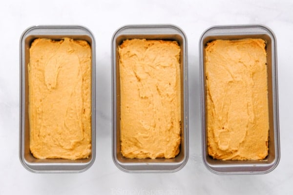 three loaf pan full of sweet potato bread batter