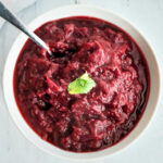 closeup of instant pot cranberry sauce recipe in a white bowl with a spoon