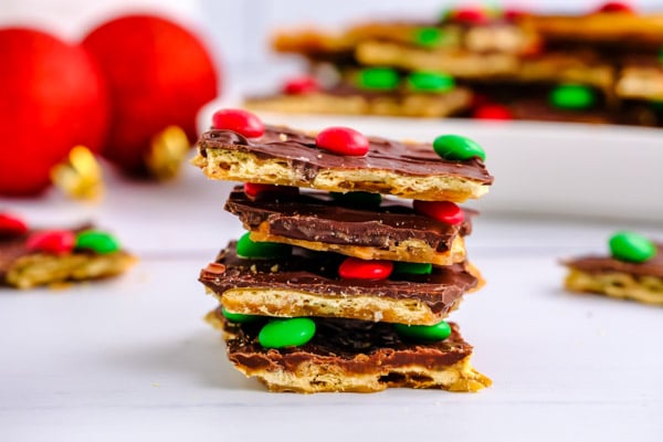 a stack of four pieces of saltine cracker toffee 