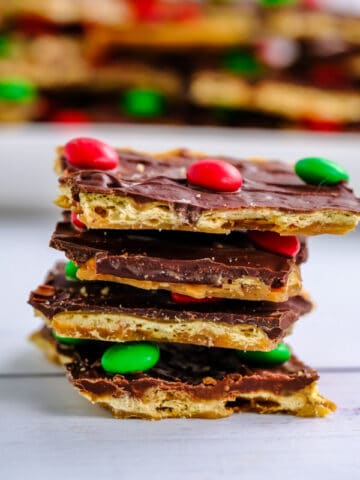stack of four pieces of Christmas crack candy topped with m&m's on