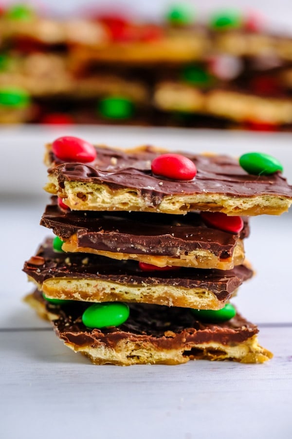 stack of four pieces of Christmas crack candy topped with m&m's on 