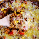 closeup of crockpot mexican casserole with scoop on a wooden