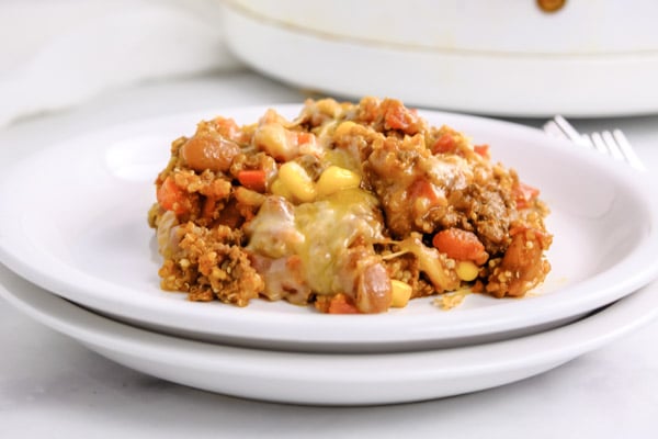 mexican casserole with quinoa and cheese on a white plate