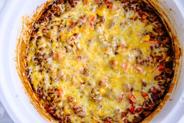 crockpot mexican casserole topped with melted cheese