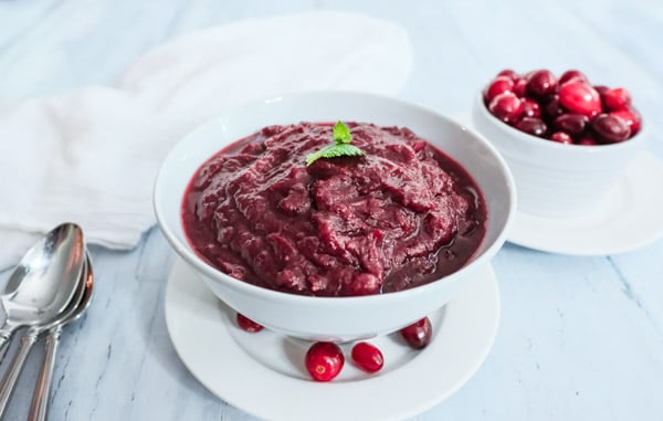 a white bowl full of cranberry sauce