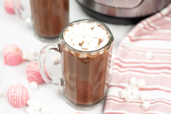 hot cocoa in a glass mug topped with mini marshmallows