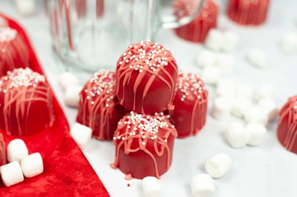four red hot chocolate bombs stacked