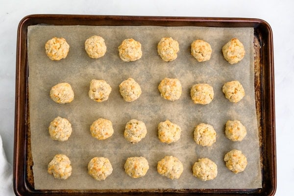 a baking sheet with 24 sausage balls