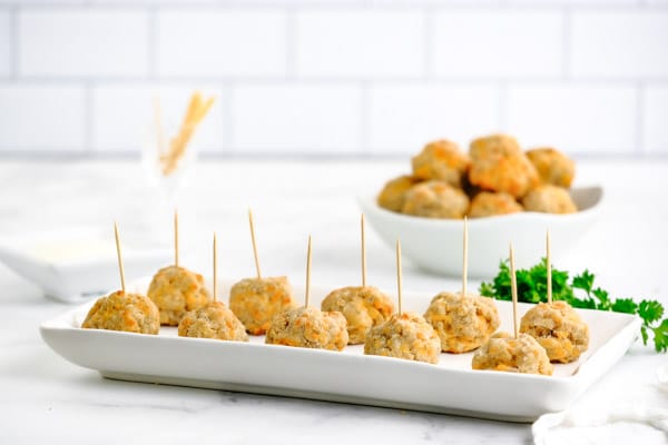 a tray full of sausage balls with toothpicks 