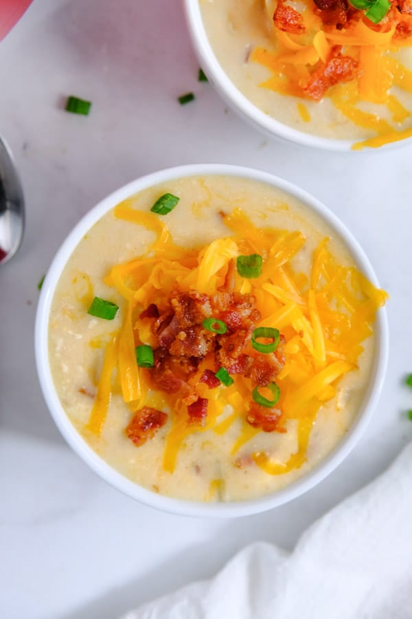 potato soup topped with shredded cheese, bacon crumbles and green onions