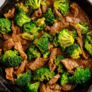 beef and broccoli in a cast iron skillet