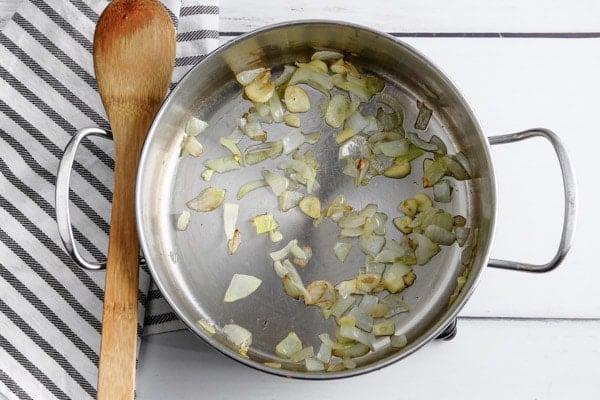 stainless steel pot with onions sauteing