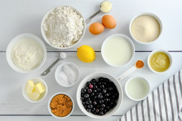 ingredients for lemon blueberry muffins in small bowls and measuring spoons