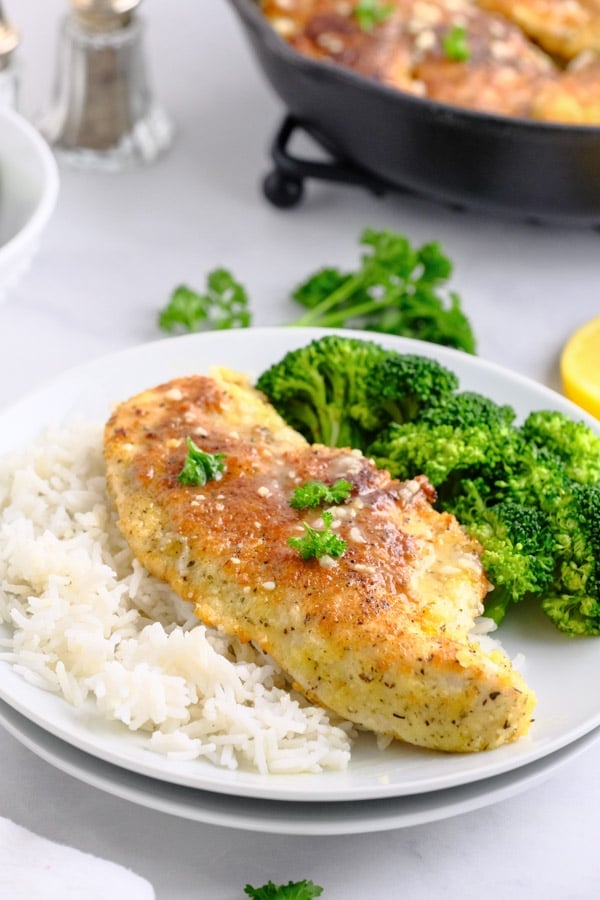 chicken breasts rice and broccoli on a white plate