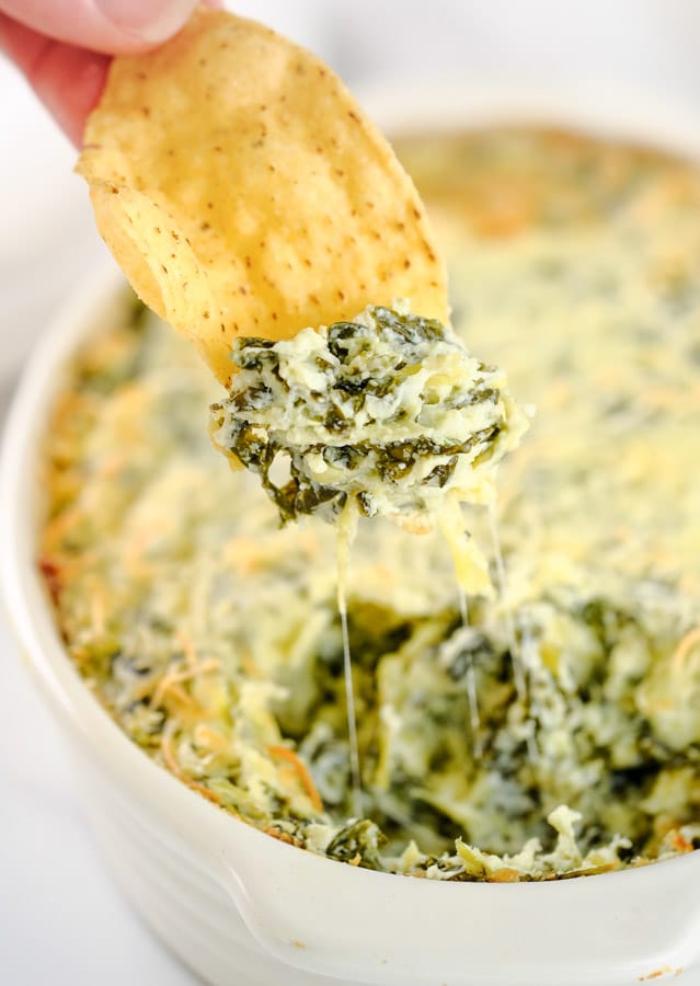 spinach artichoke dip on a tortilla chip.