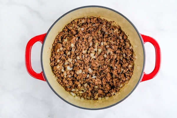 cooked ground beef and onions in a pot