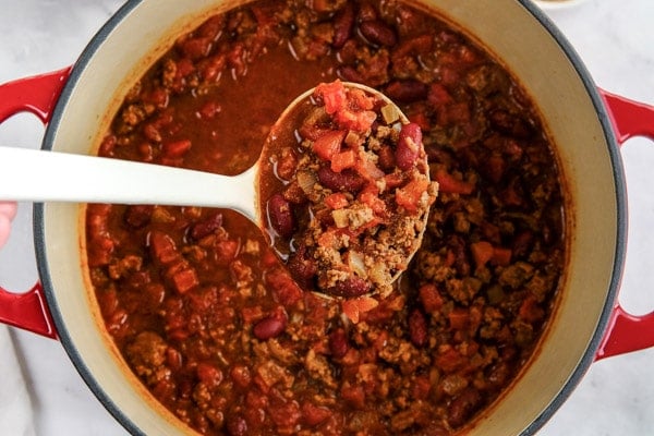 a big spoonful of chili over a pot full