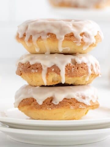 closeup of a stack of three vanilla glazed donuts