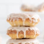 stack of three glazed donuts on a white plate with text overlay easy baked donuts